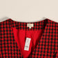 A close-up of a red and black tweed houndstooth. Garment new with NY & Co tag showing a bright red inner lining and a white 'luna' brand neck label.