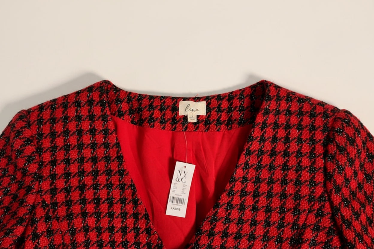 A close-up of a red and black tweed houndstooth. Garment new with NY & Co tag showing a bright red inner lining and a white 'luna' brand neck label.