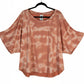 Adidas 11 HONORE' 2X loose, short-sleeve top in a peachy orange color with a white tie-dye pattern.