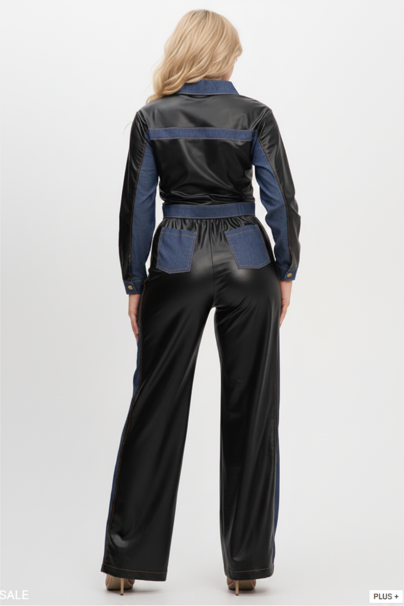 A model viewed from the back wearing a black and blue two-tone 2-piece set with a faux-leather finish and denim-like side panels.